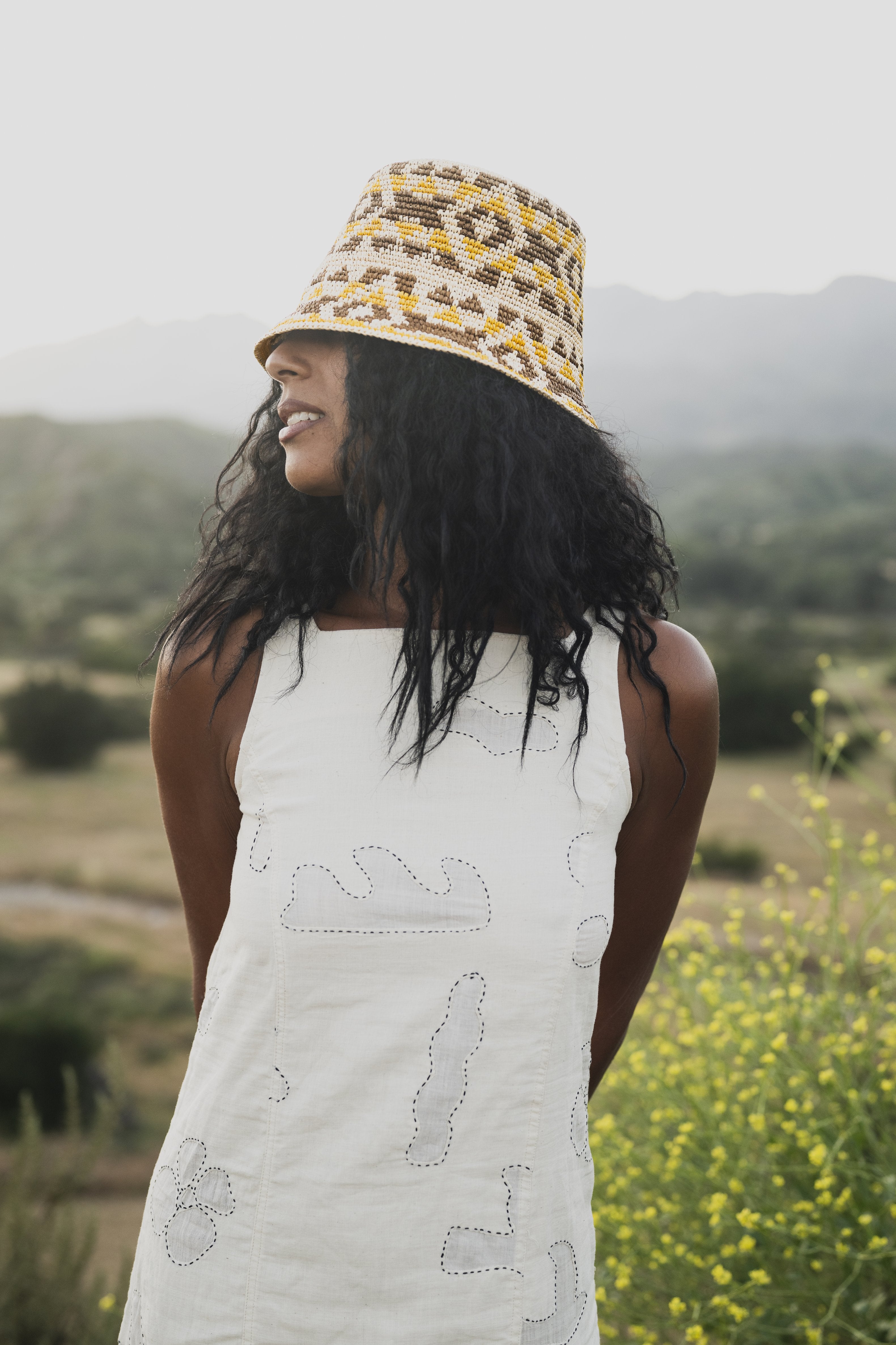 Chicha Straw Bucket hat styled outdoors, lifestyle setting.