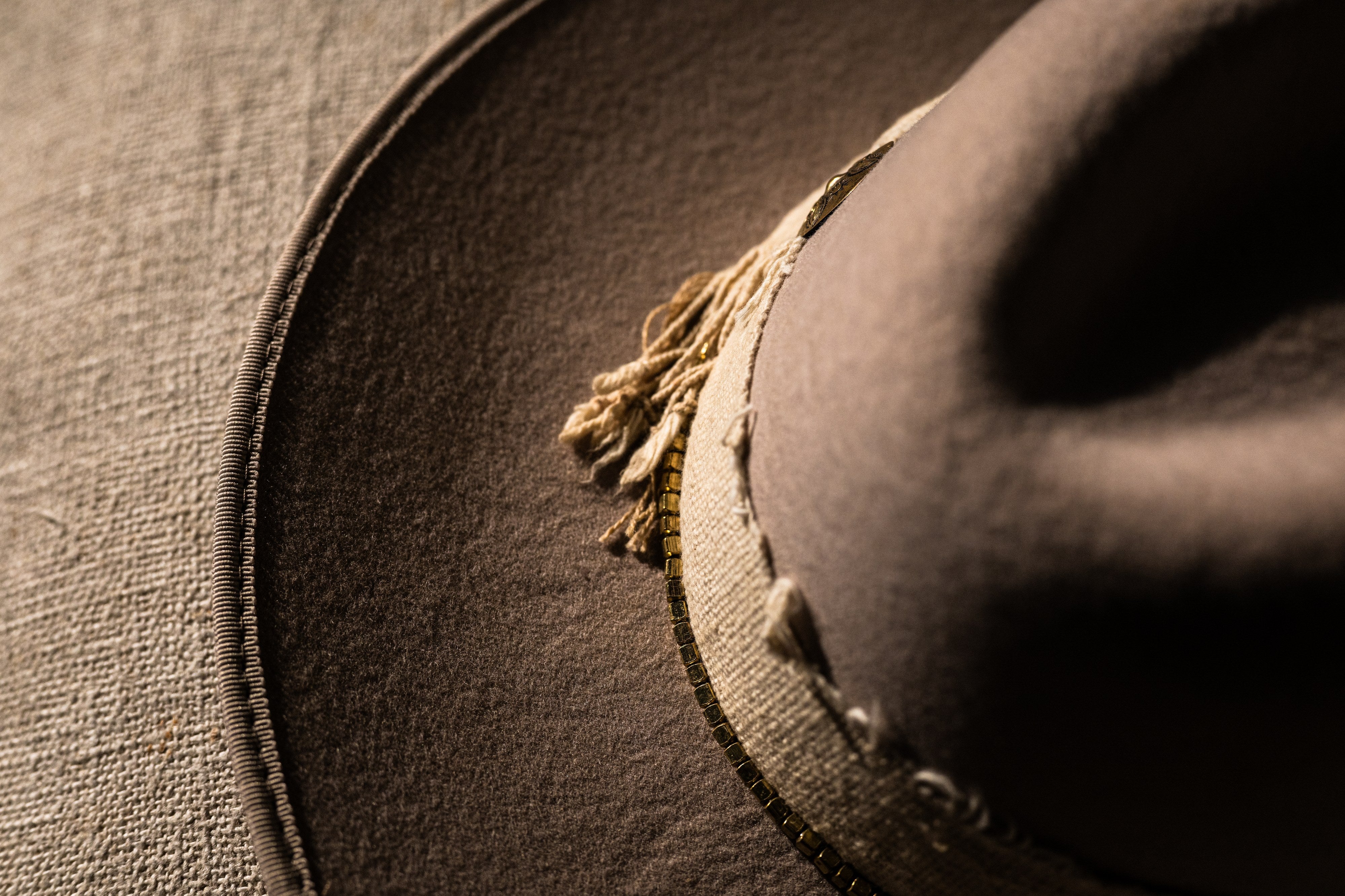 Colorado Summer band detail showing frayed ivory linen over a metallic bead row.