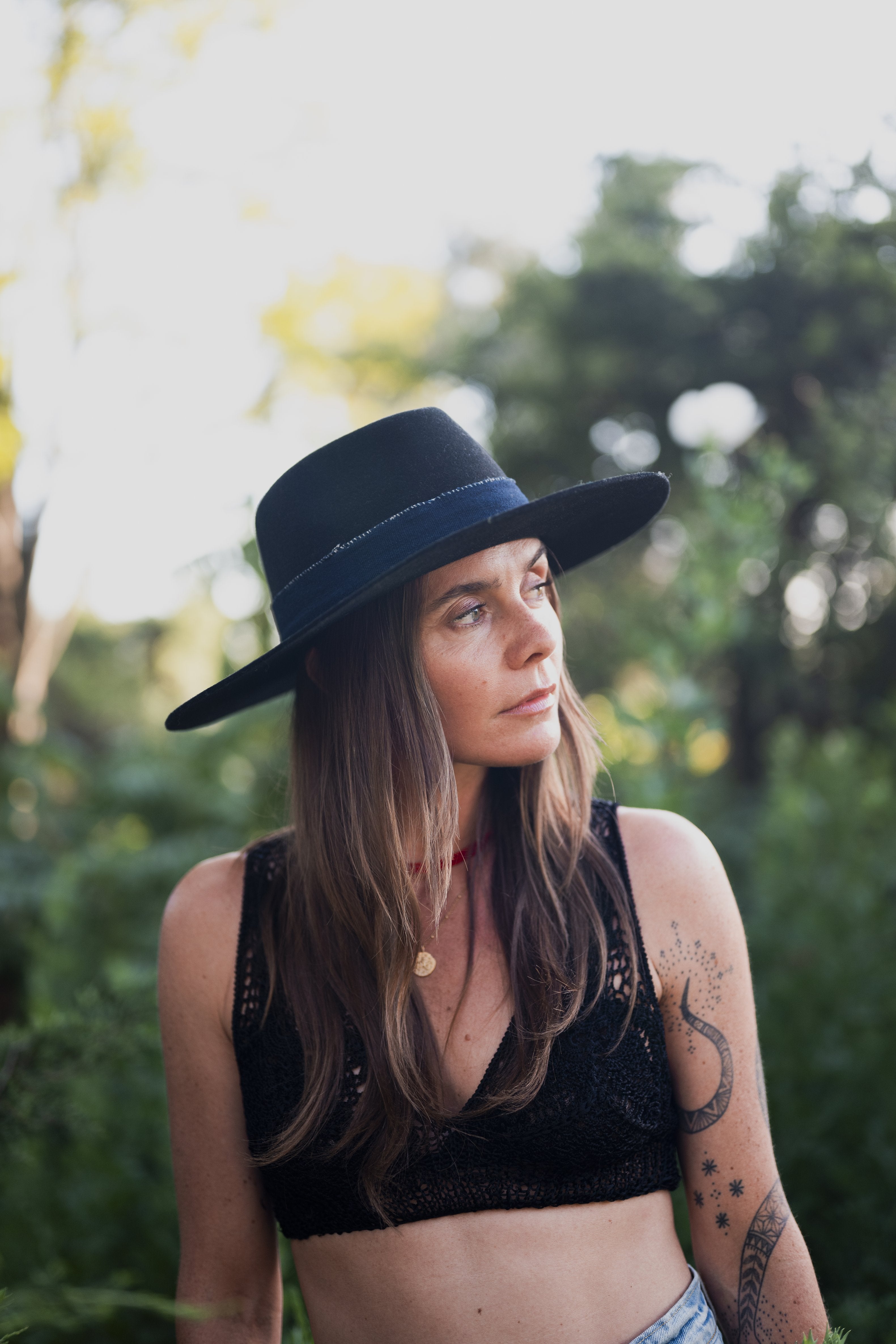 Coyote Call hat styled outdoors, lifestyle setting.