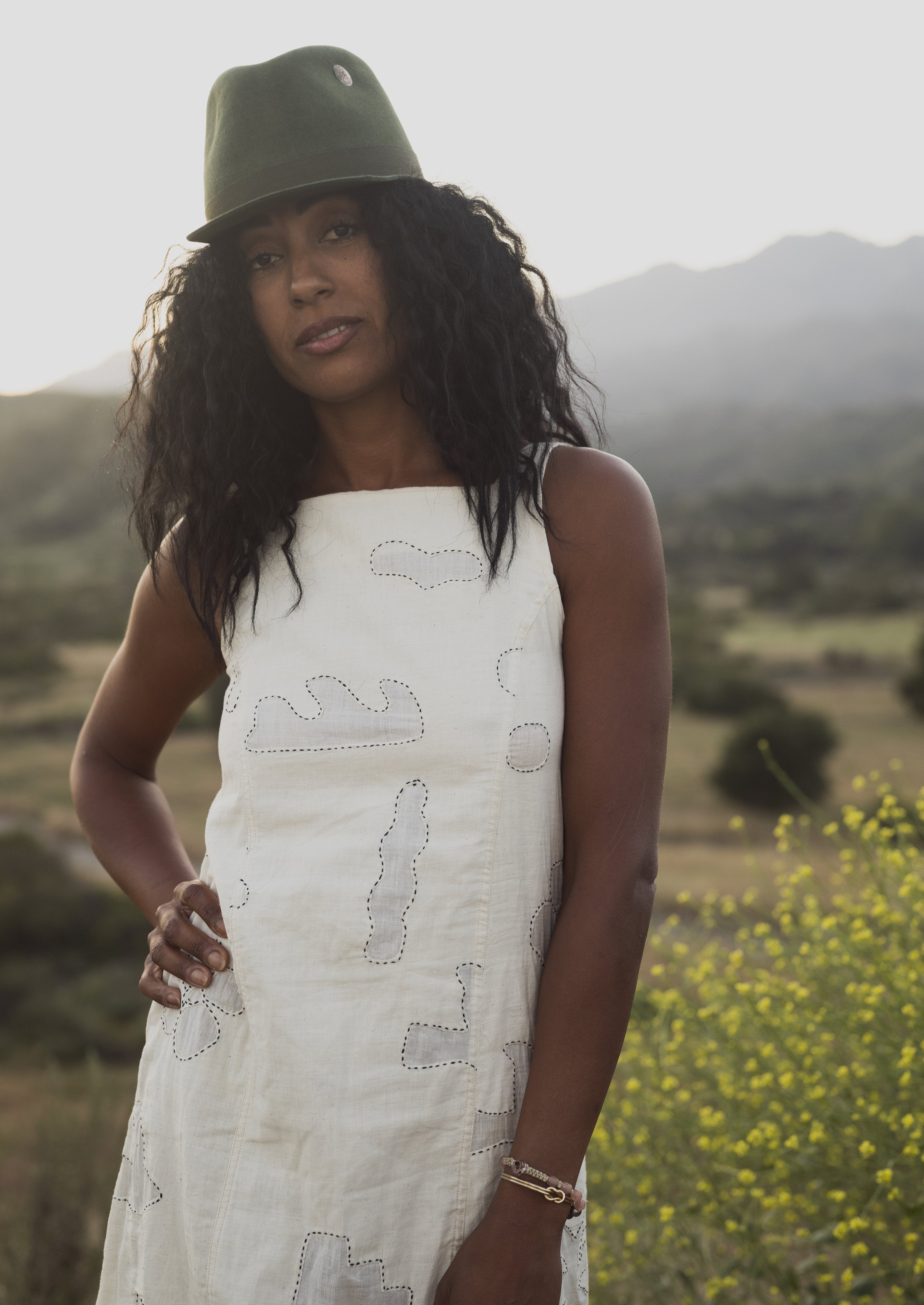 Hilltop hat styled outdoors, lifestyle setting.